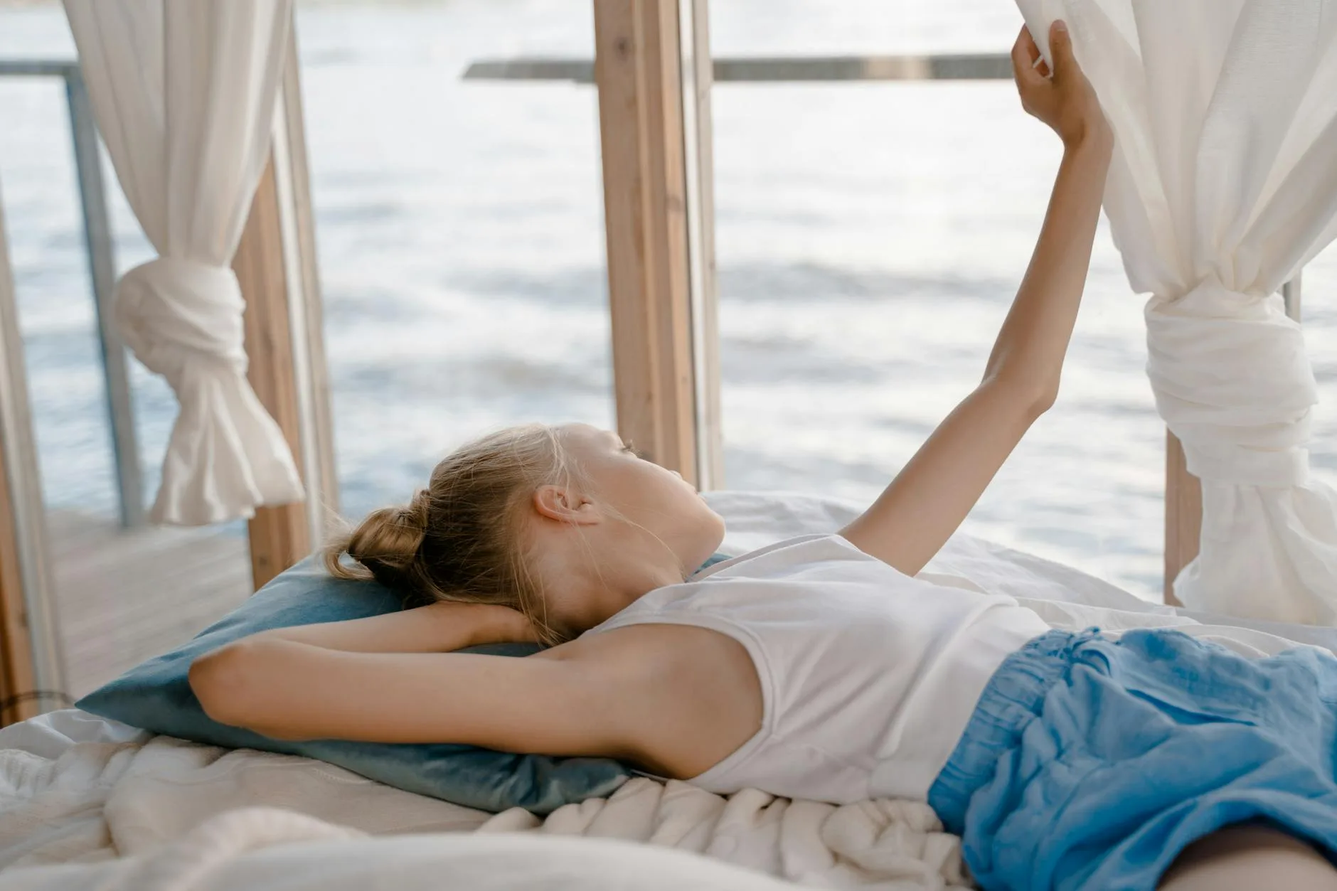 Bedroom window open with fresh air and light curtains