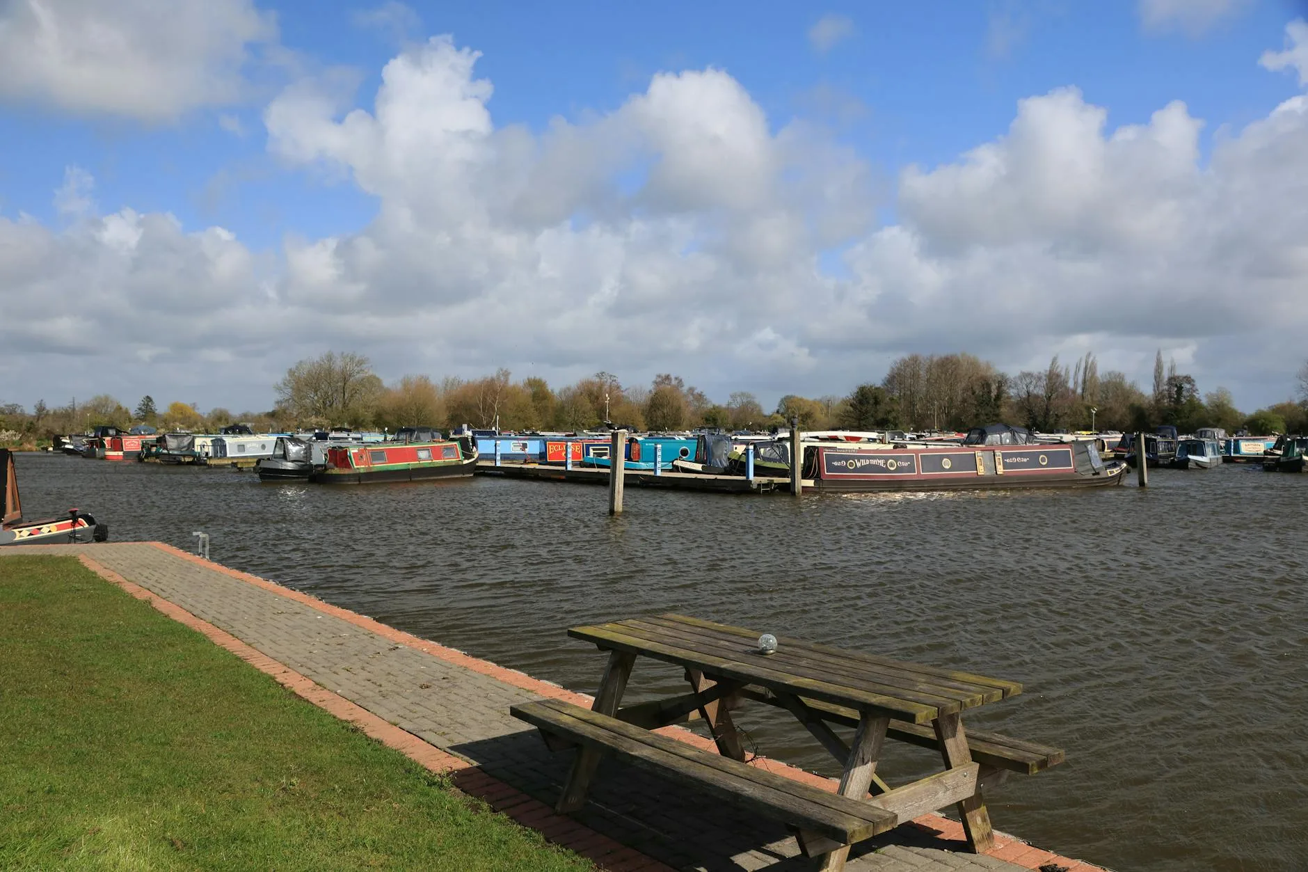 Narrowboat moored at a UK canal marina in autumn