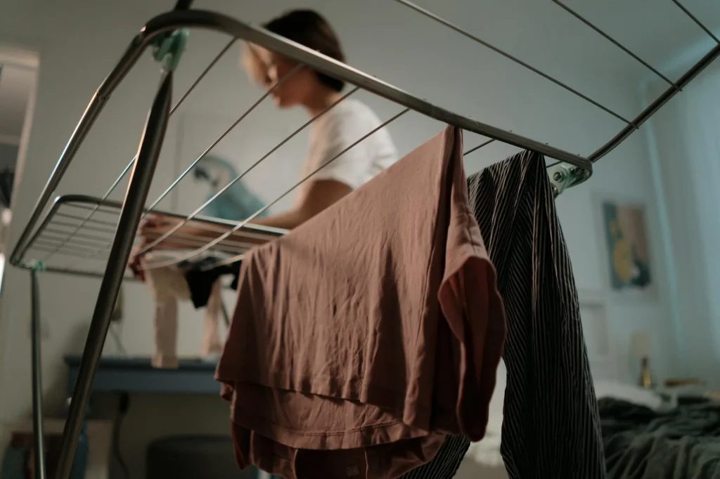 Wet clothes hanging to dry inside a living room