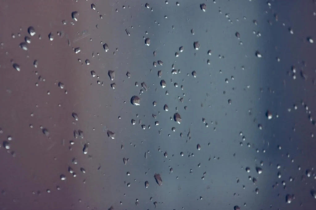 Water droplets from condensation on a window pane in winter
