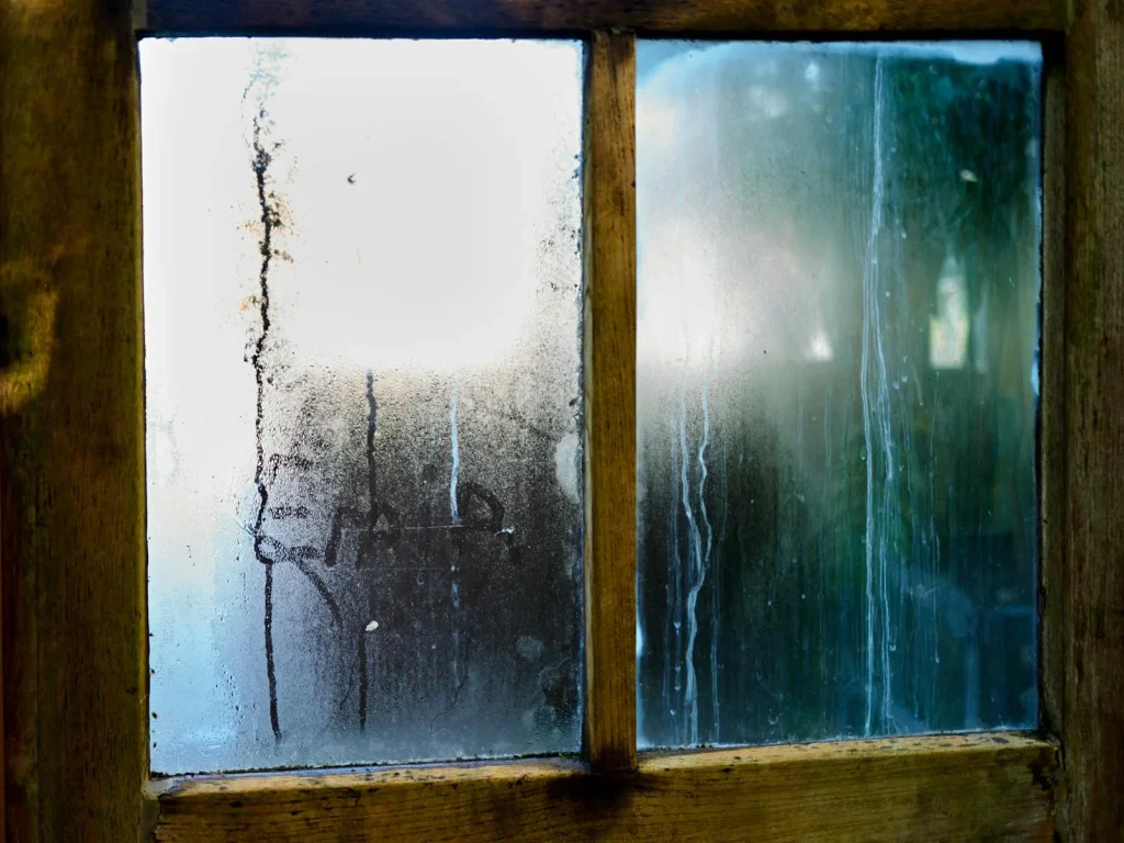 Condensation and water droplets on a window pane caused by high indoor humidity