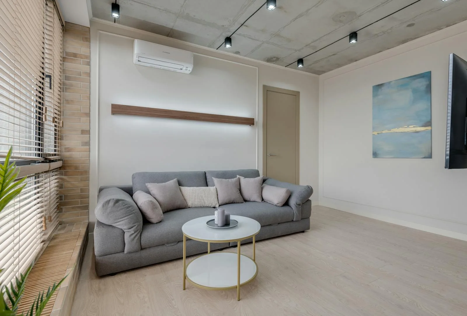 Modern living room with wall-mounted air conditioning unit for humidity control