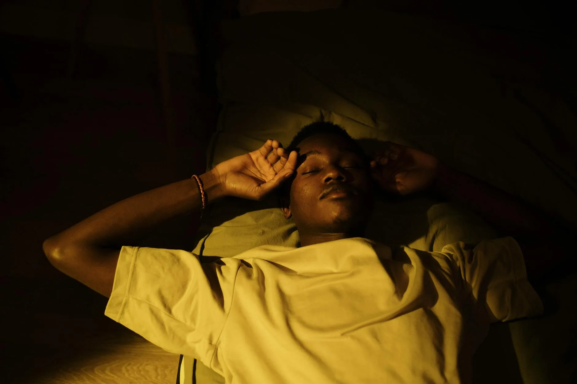 Person sleeping peacefully in a quiet dark bedroom