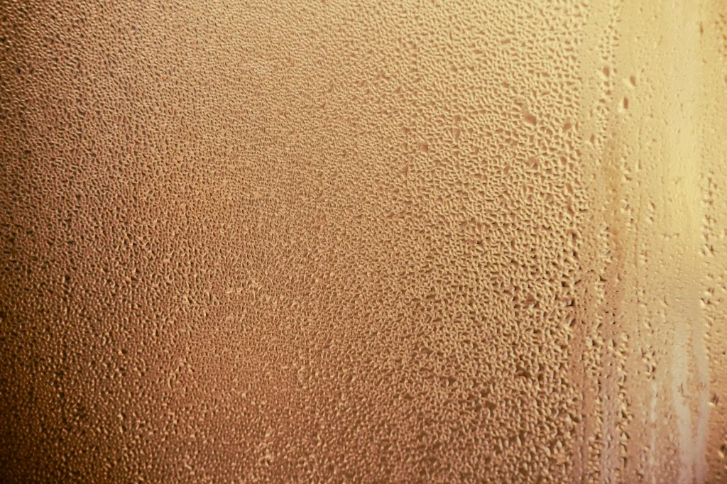 Condensation and moisture on bathroom tiles after a hot shower