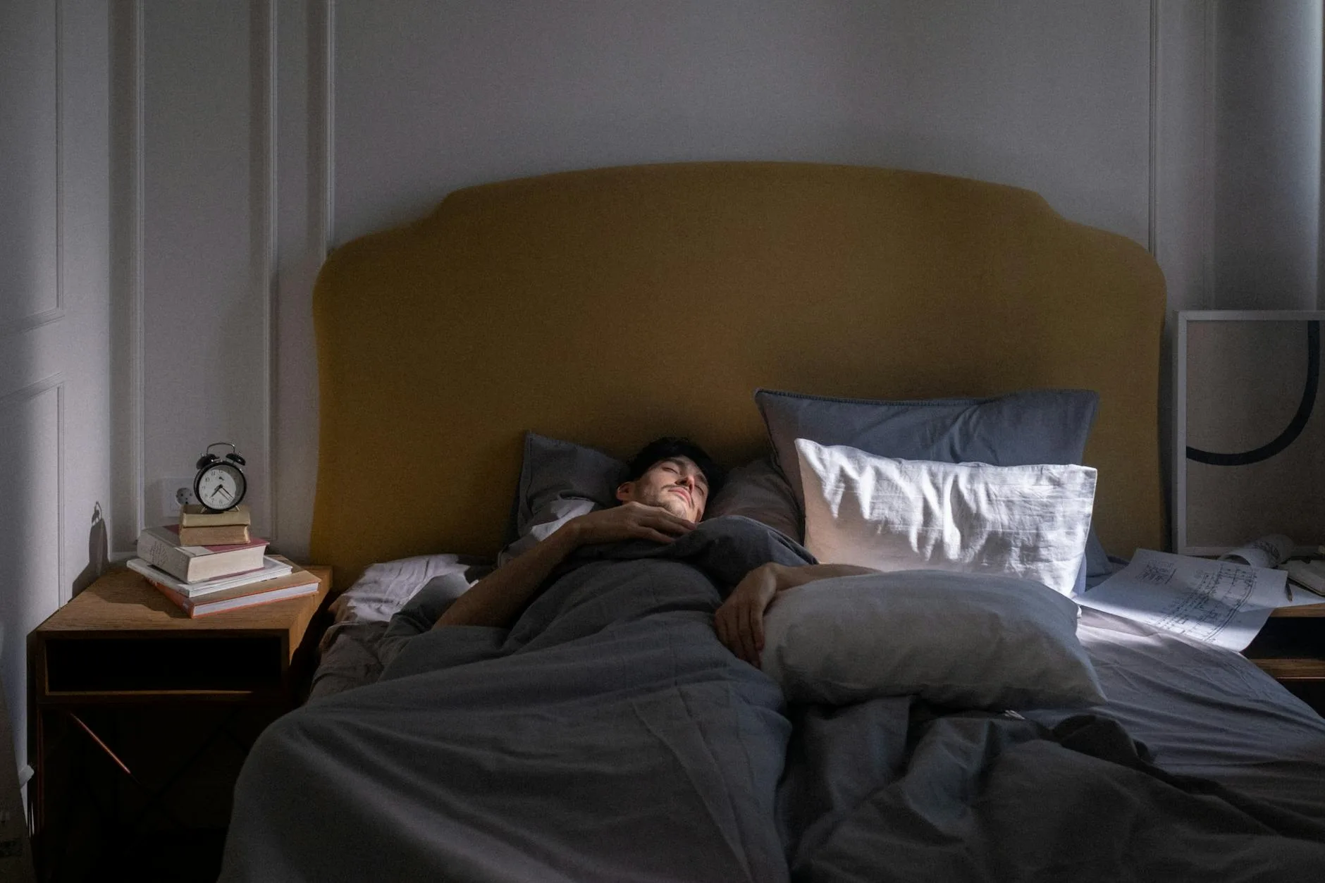 Air purifier running quietly beside a bed at night