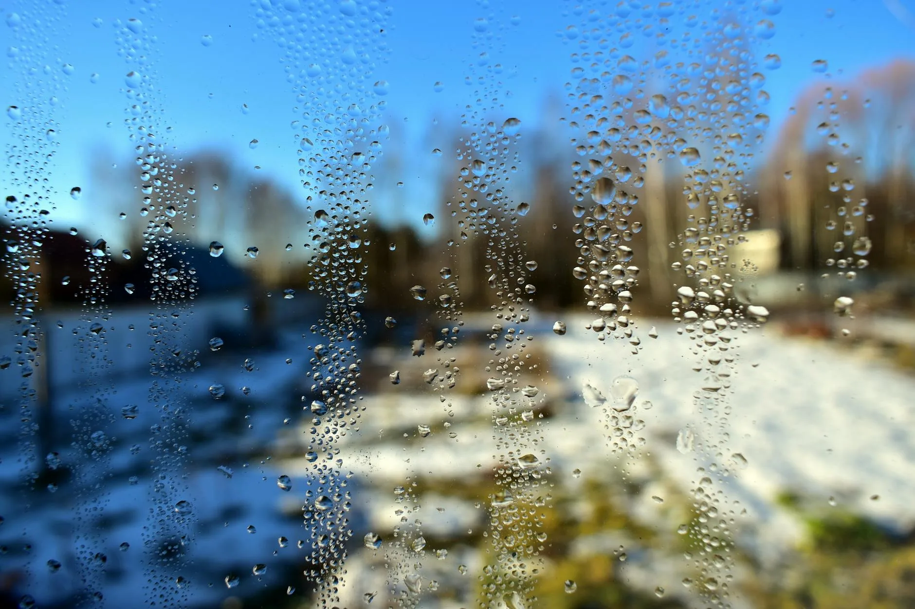 Condensation water drops on a cold window in winter