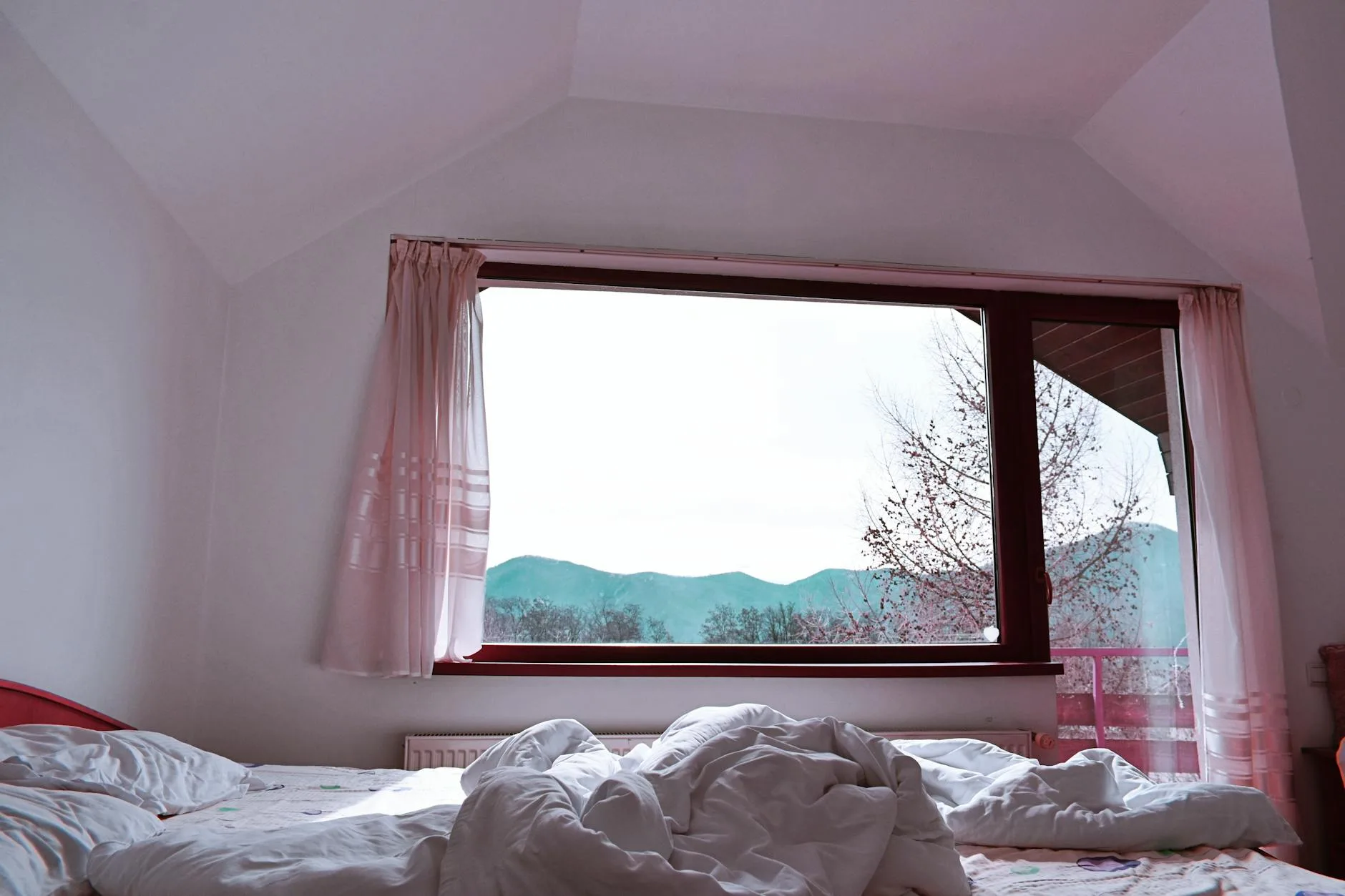 Bedroom with morning light through curtains for overnight CO2 monitoring