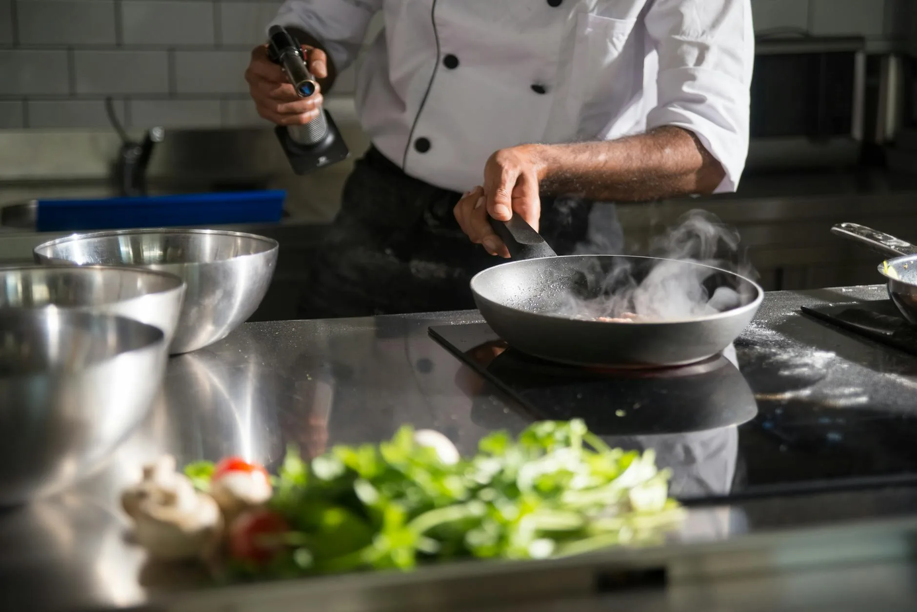 Steam and fumes rising from cooking on a kitchen hob