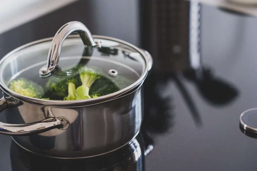 Covered pan on hob showing cooking indoor air quality
